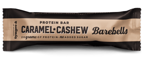 Barebells Caramel Cashew protein bar packaging on a black background