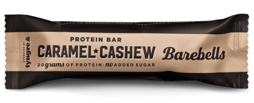 Barebells Caramel Cashew protein bar packaging on a black background