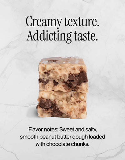 Stack of peanut butter bars with chocolate chunks on a white background.